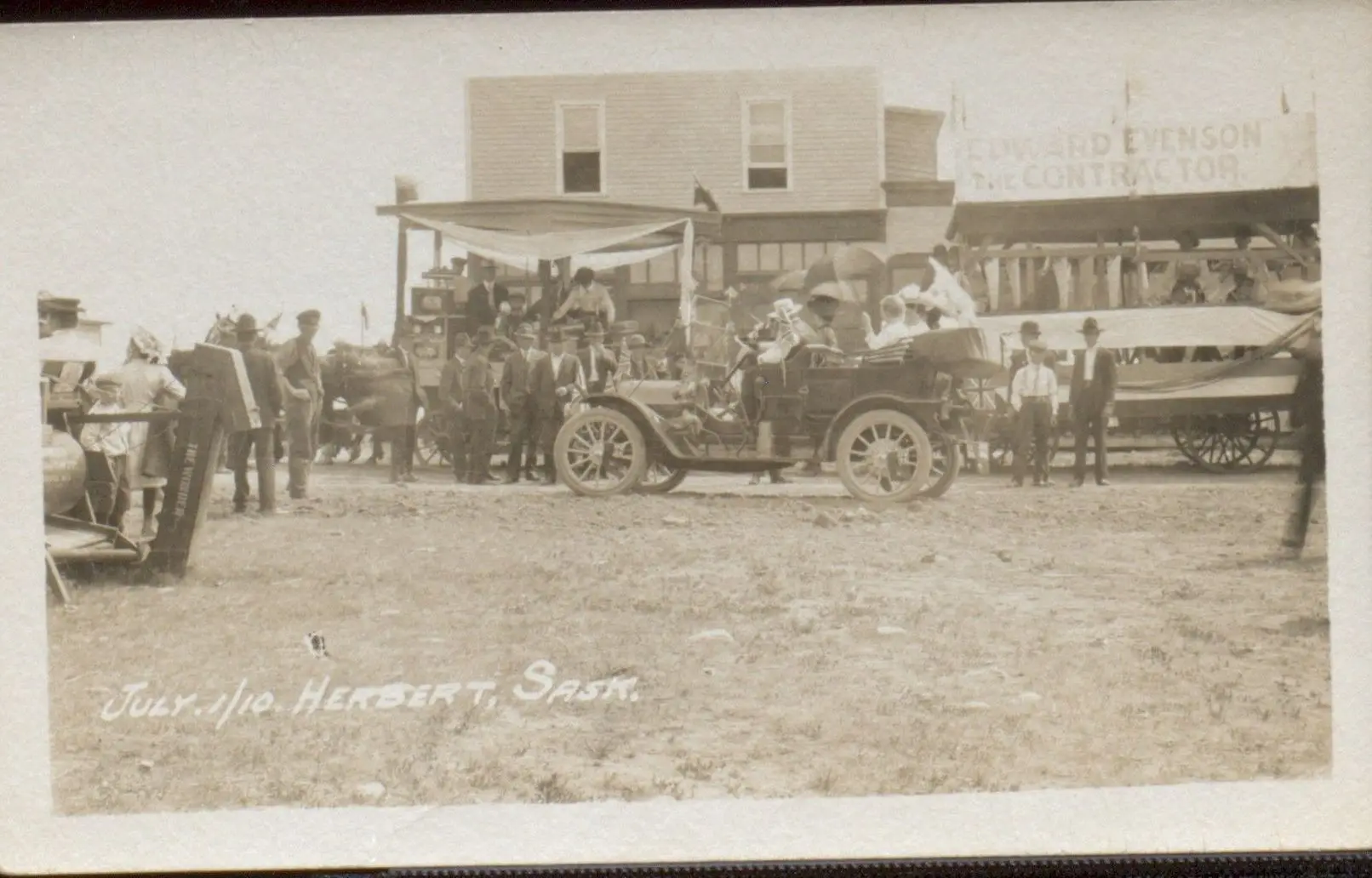 Parade day with early automobile and floats, Herbert